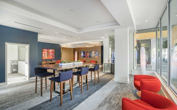 coworking lounge with a long table and blue chairs